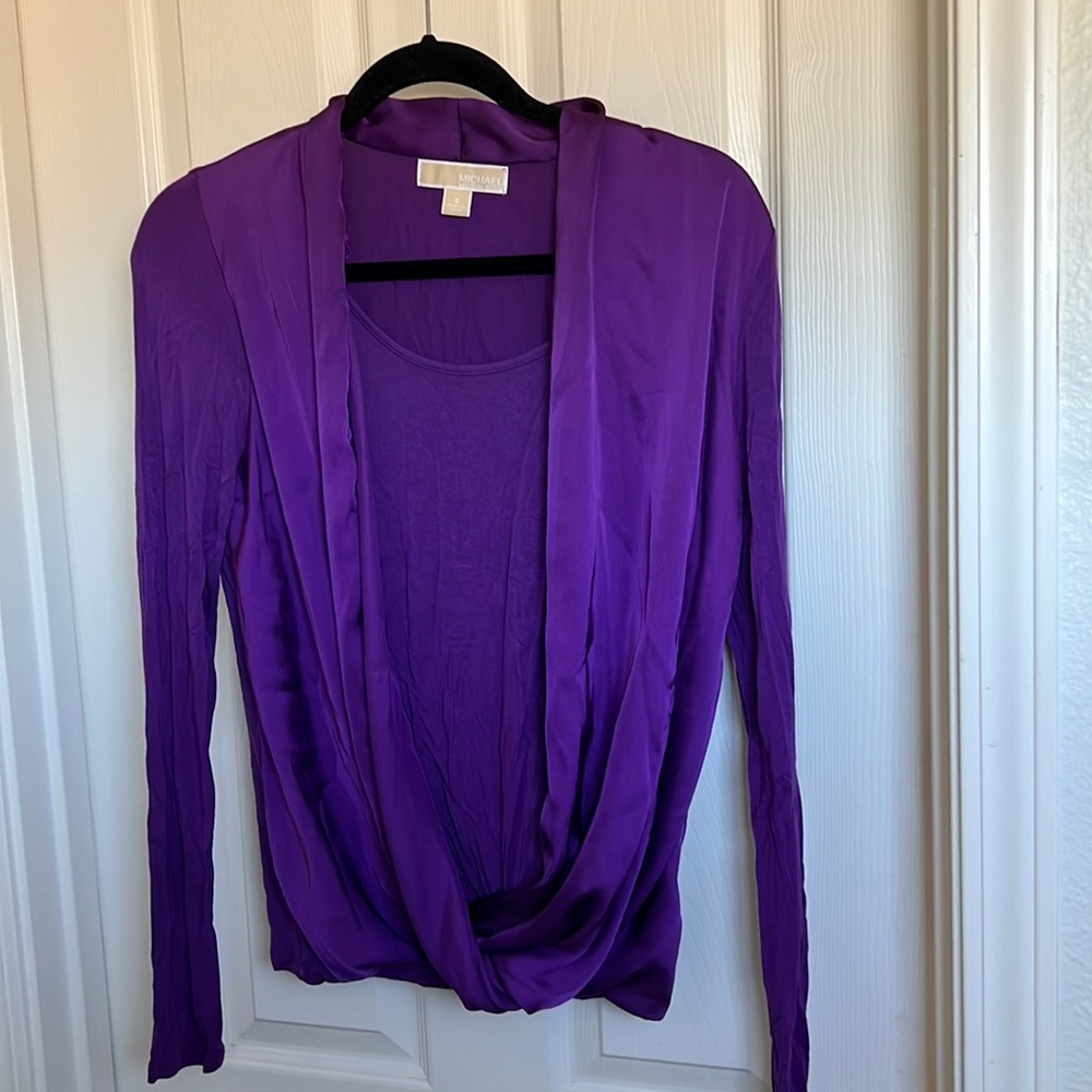 This is a Michael Kors blouse. It’s a size Small, purple in color.